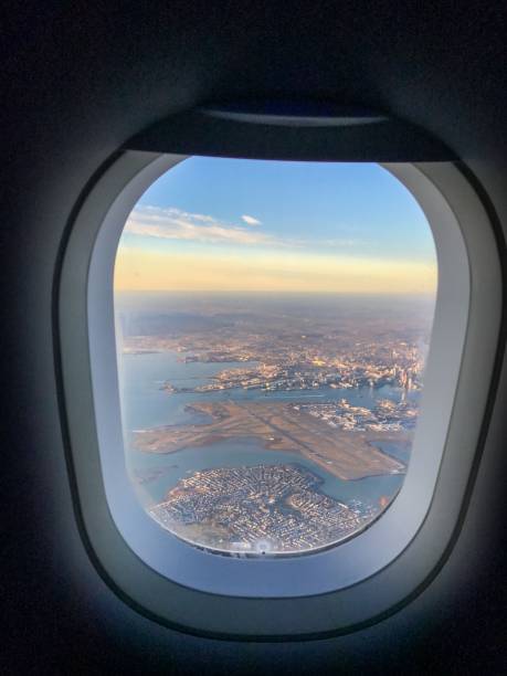 istock Aerial cityscape through airplane window at sunrise. 2182797864
