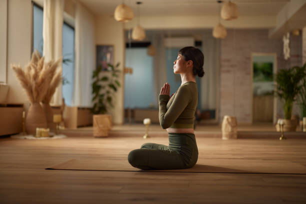 istock Relaxed Japanese woman doing relaxation exercises at Yoga studio. 2182804106