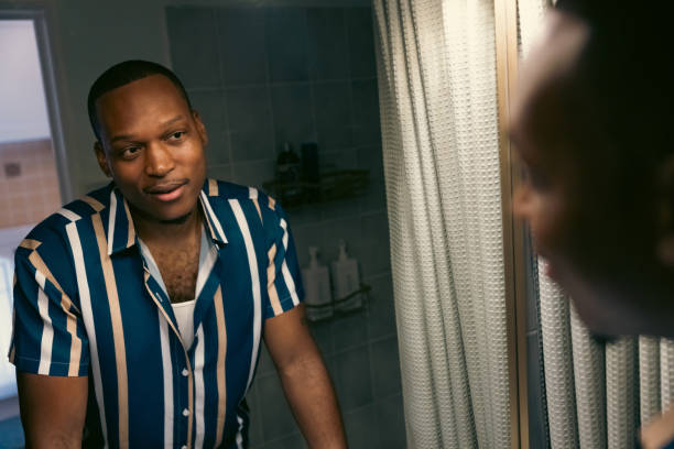 istock Young man looking at the bathroom mirror 2182805308