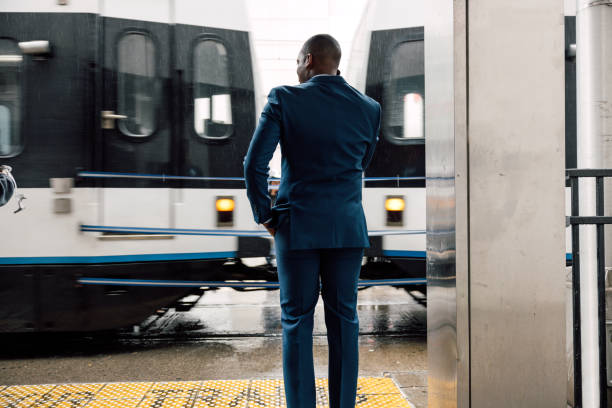 Businessman commuting to work. Waiting at the train stop
