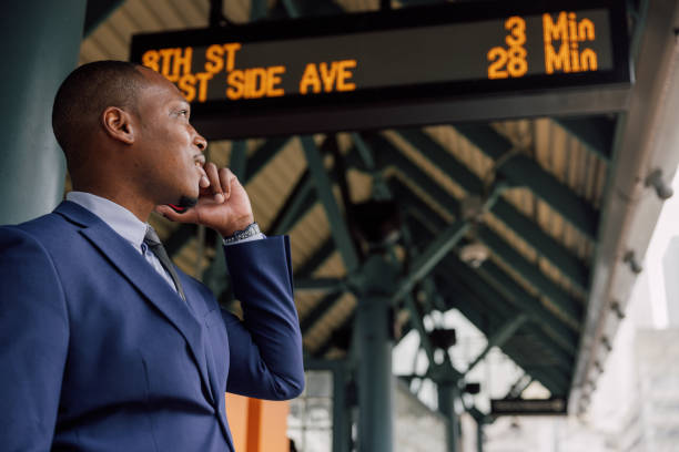 istock Businessman commuting to work. Waiting at the train stop 2182807483
