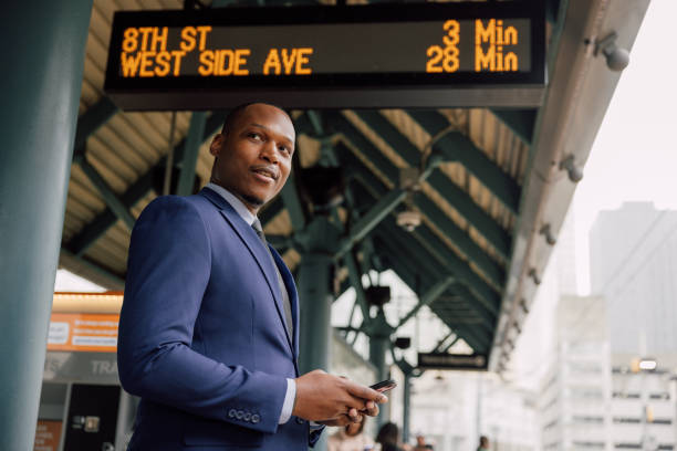 istock Businessman commuting to work. Waiting at the train stop 2182807525