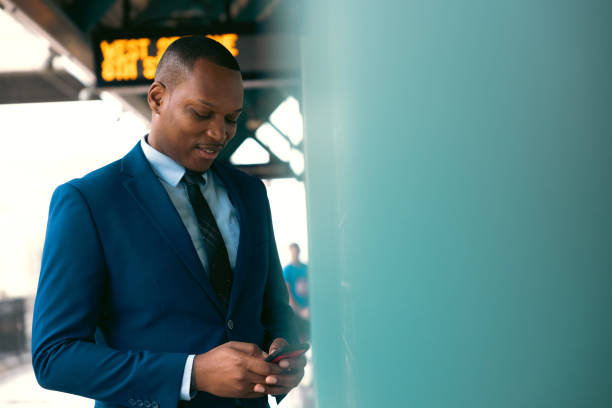 istock Businessman commuting to work. Waiting at the train stop 2182807816