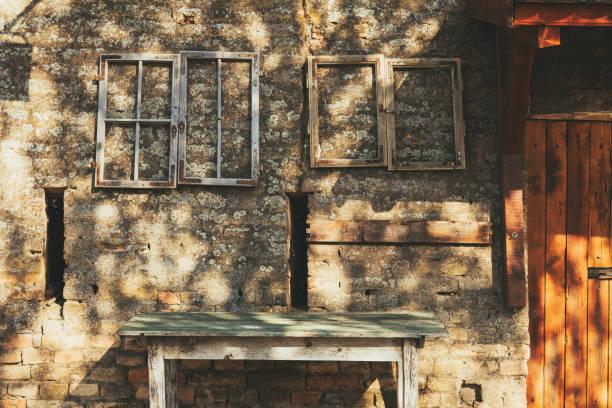 istock Old wooden table and window frames against the ruined brick wall 2182807941