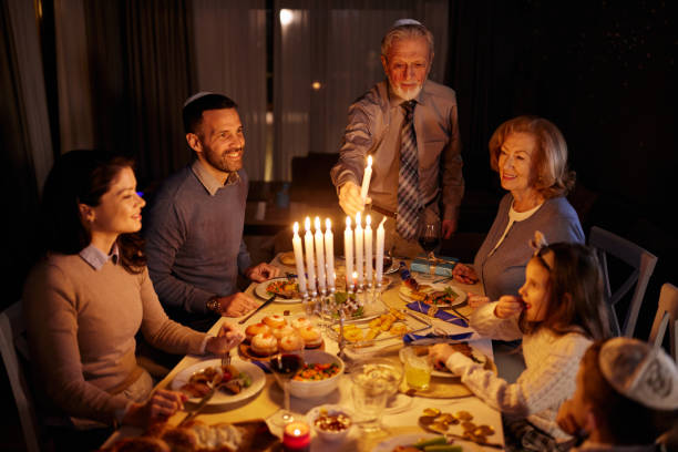 istock Lightning candles on Menorah before dinner on Hanukkah! 2182809819