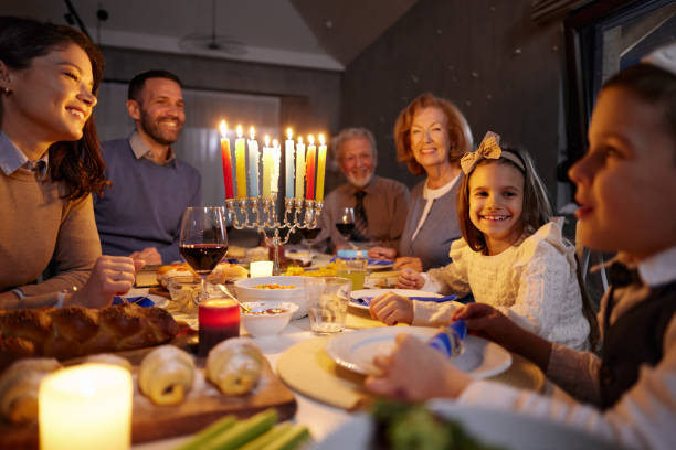 istock Happy extended family talking while having dinner on Hanukkah. 2182809988