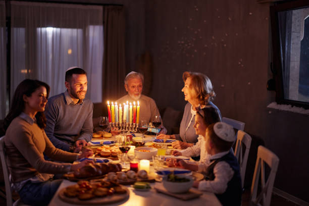 istock Happy extended family talking during a meal on Hanukkah. 2182810711