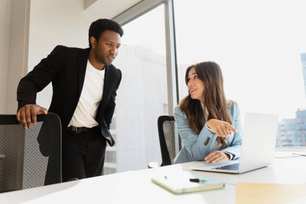 istock Business colleagues discussing work at laptop in modern office 2182810932