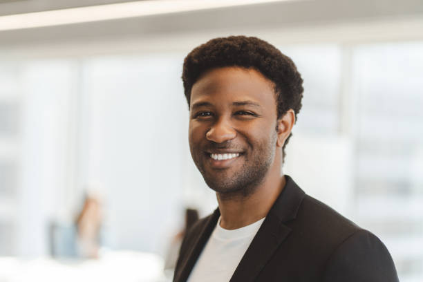 istock Smiling businessman wearing suit in modern office setting 2182811011