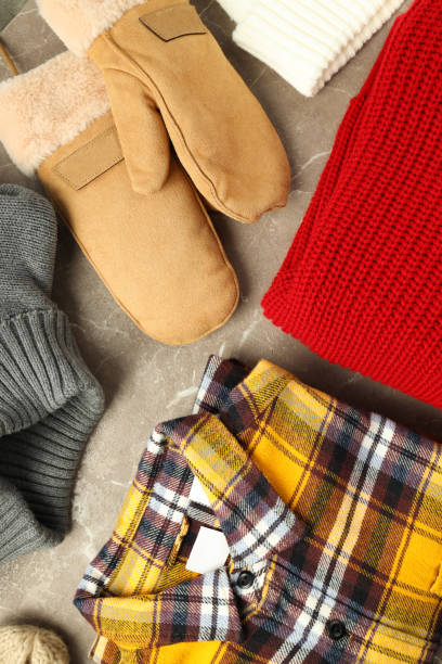 istock Concept of winter clothes on gray textured table 2182812161
