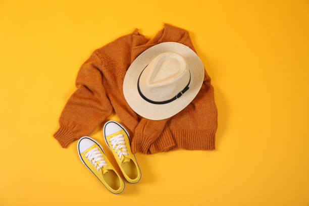 istock Sweater, sneakers and hat on yellow background 2182813711