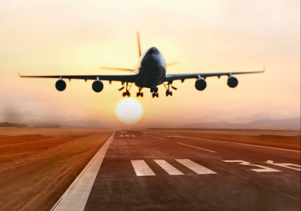 istock Passenger airplane is landing at sunset 2182814603
