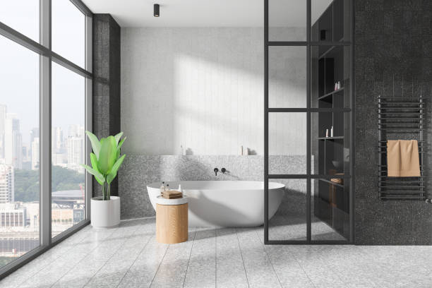 istock Modern hotel bathroom interior with tub, shelf with accessories and window 2182814820