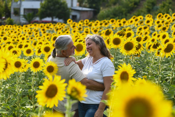 MIDDLE-AGED MAN AND WOMAN IN THE FLOWER FIELD