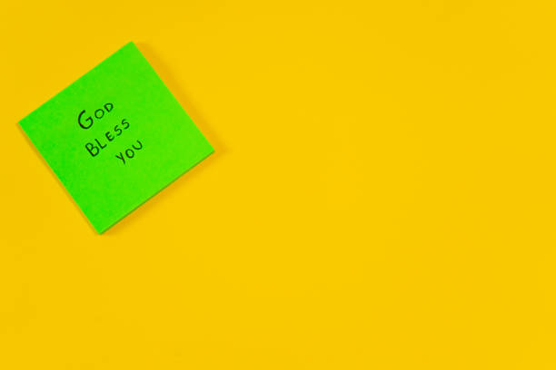 istock Motivational green sticky note message saying God bless you isolated on yellow background with copy space 2182818445