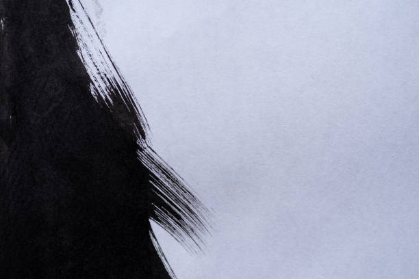 istock Black ink splashing on a dark background 2182820617