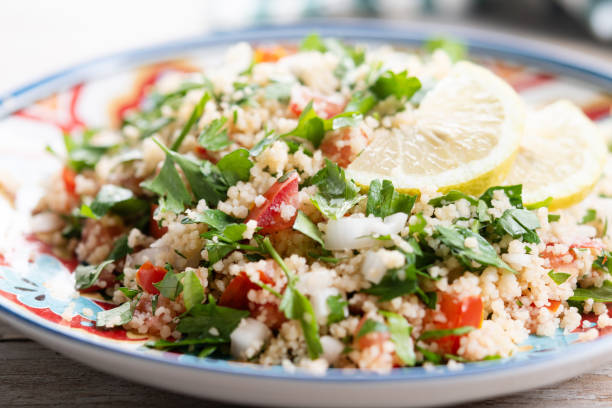 istock Tabbouleh salad with couscous on wooden table 2182821503