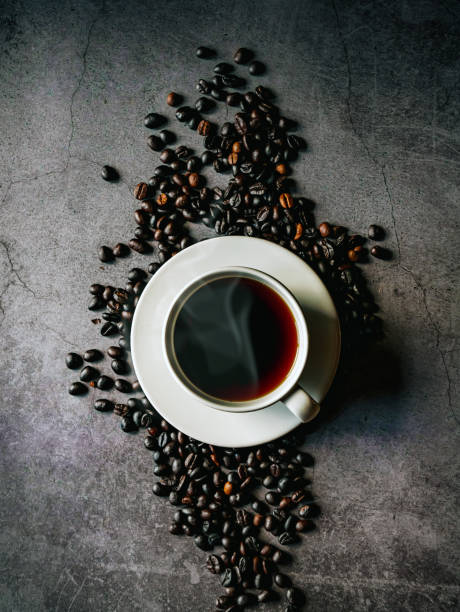 istock Black coffee cup and coffee beans on gray background, Black coffee cup aromatic, top view 2182822668