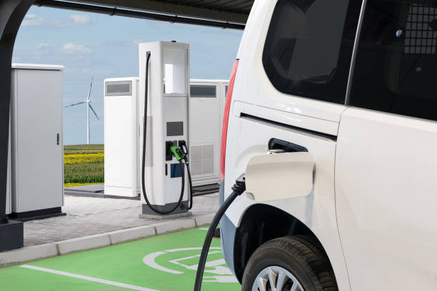 istock Electric delivery van with electric vehicles charging station 2182822894