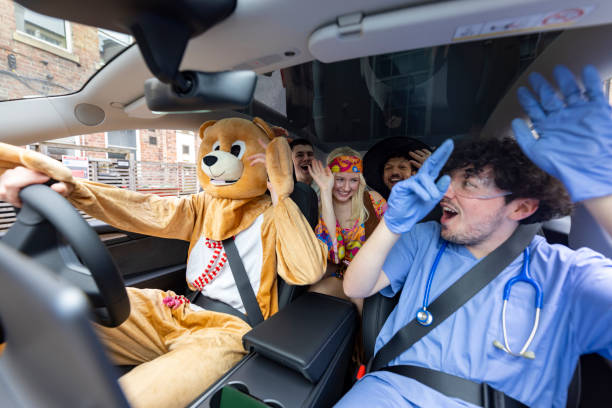 istock Fancy Dressed Friends in a Car 2182824054