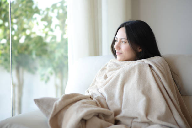 istock Relaxed woman resting covered with blanket at home 2182824073