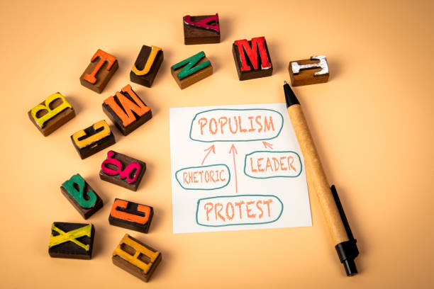 istock POPULISM. Notepad and wooden alphabet letters on a light background 2182825845