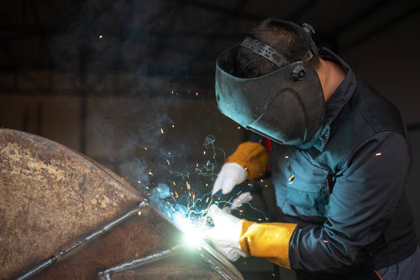 istock Industrial worker welding metal in workshop wearing protective gear 2182826069