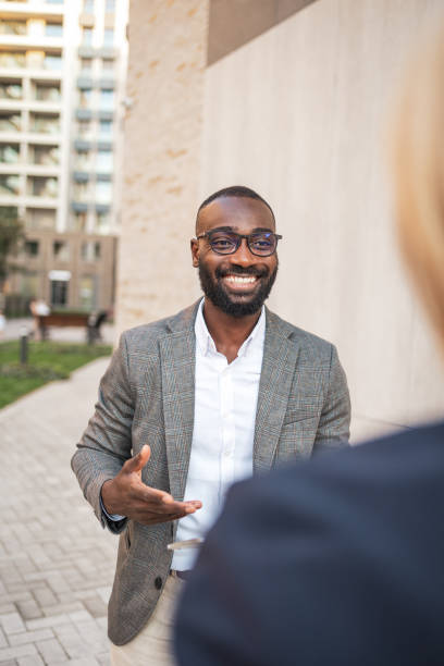 istock Smiling businessman engaging in conversation outdoors in urban setting 2182827897