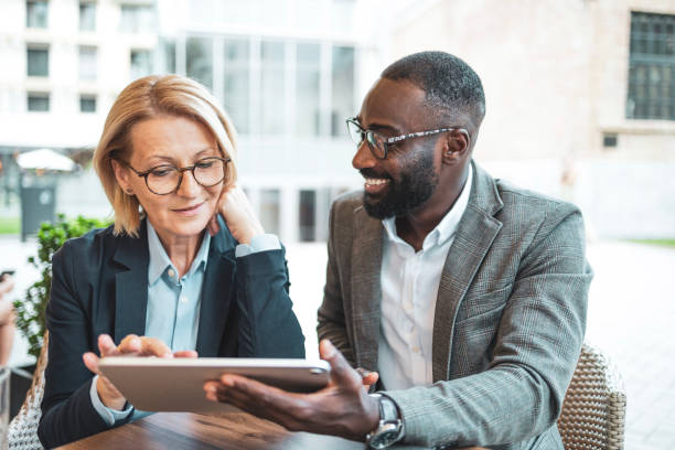 istock Business professionals collaborating outdoors with a digital tablet 2182827932