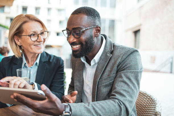 istock Business colleagues using a digital tablet in an outdoor cafe setting 2182827936