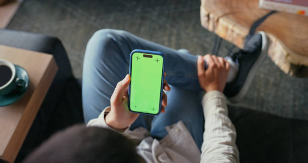 istock Green screen, hands and scrolling with smartphone, home and subscription to app, reading and article. Browsing, display and person with mobile, tracking markers and online for news, digital or lounge 2182828756