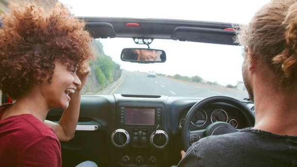 istock Young Couple Driving Open Top Hire Car On Summer Vacation 2182830057