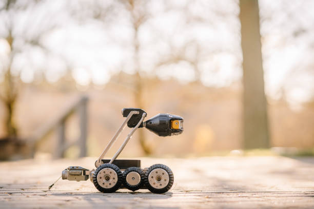 istock A four-wheeled inspection robot with a camera, sitting on an outdoor pavement in sunlight, ready for monitoring or exploration tasks. 2182833498