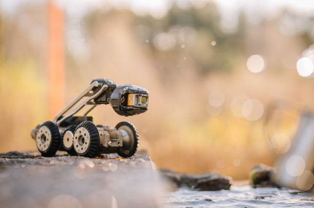 istock A compact, wheeled inspection robot on a reflective surface, with a blurred natural background, suggesting outdoor exploration and technology. 2182833622
