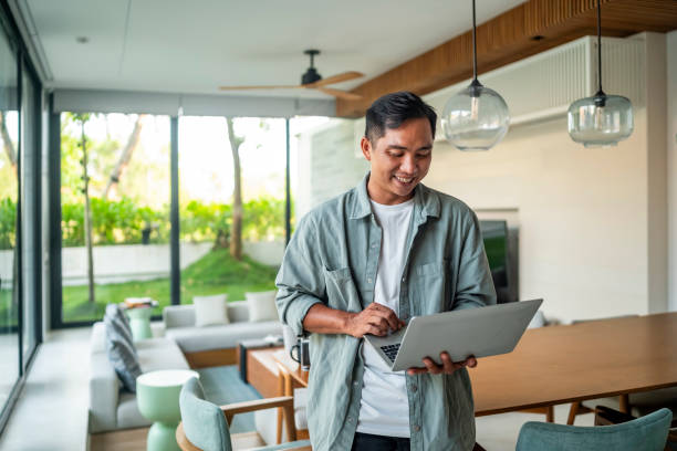 istock Happy Man Using Laptop in Modern Home Living Room 2182833811