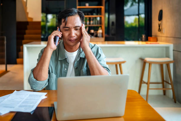 istock Stressed Man on Phone Call Working from Home 2182833951
