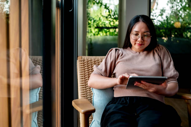 istock Woman Relaxing at Home Using a Digital Tablet 2182833978