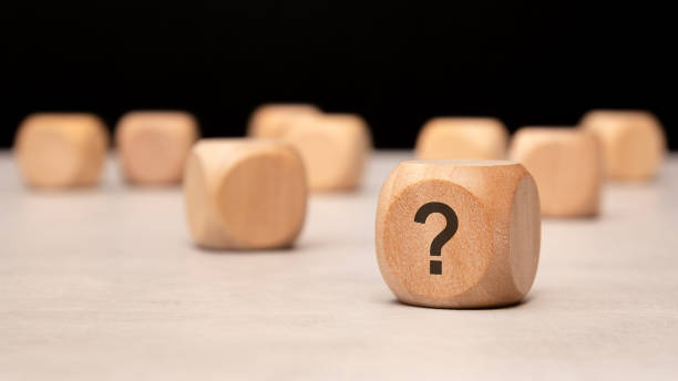 istock Wooden blocks featuring a prominent question mark arranged thoughtfully on a table surface 2182834646