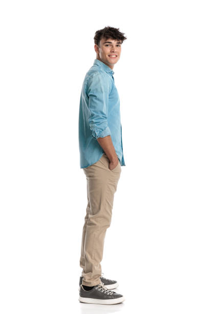 istock casual young man standing in line with hands in pockets 2182839251
