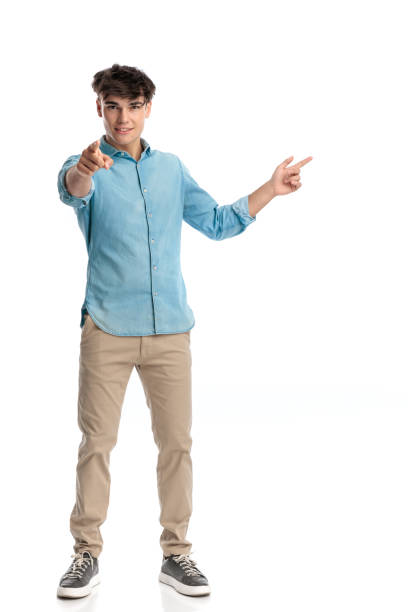 istock confident student in his 20s pointing finger ahead and to side 2182839611