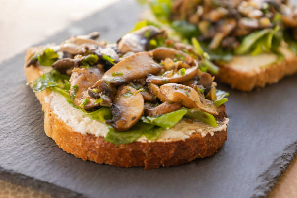 istock Toasted Bread with Ricotta, Arugula, and Mushrooms – Close-Up 2182841504
