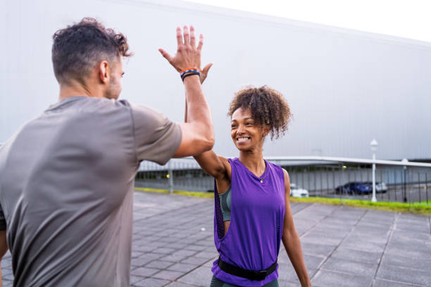 istock Two athletes high five after completing a successful outdoor workout 2182844087