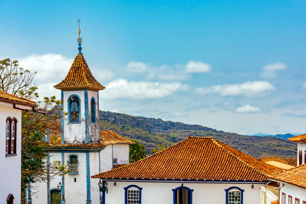 istock Church tower with bell and colonial houses 2182845239
