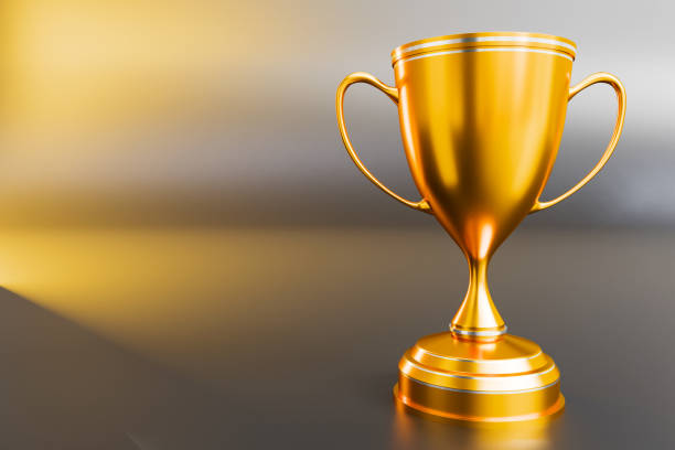 istock gold trophy award Winner trophy isolated on golden background with copy space for text. Rendering. 3D illustration. 2182849585