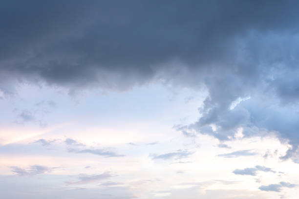 Fluffy white clouds drift across a vast, blue sky