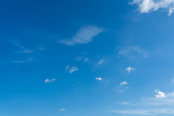 istock Fluffy white clouds drift across a brilliant blue sky 2182850002