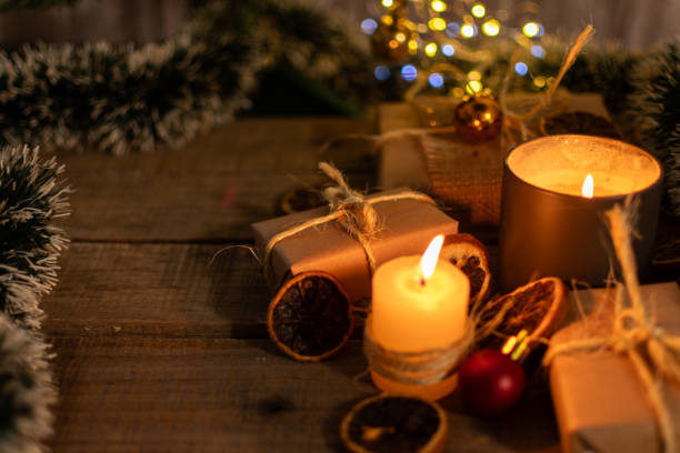 istock Christmas gifts and ornaments illuminated by candlelight. 2182850713