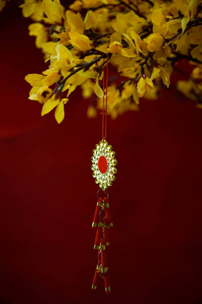 Lunar New Year decorative ornament hanging on a yellow tree with red background