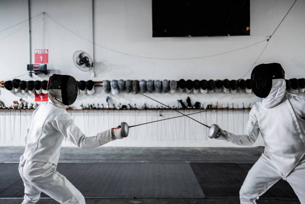 istock Men practicing fencing at a health club 2182853429