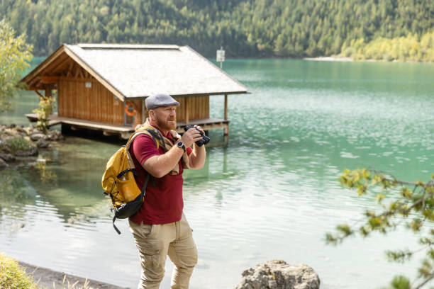 istock Handsome redhead man at a lake during an alpine forest bathing meditation trip 2182853591